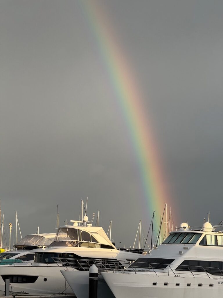 Zoom shot of rainbow in stormy skies above the marina at Hillary's Boat Harbour