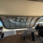 Pierced metal indigenous artwork on a visitor shade rest